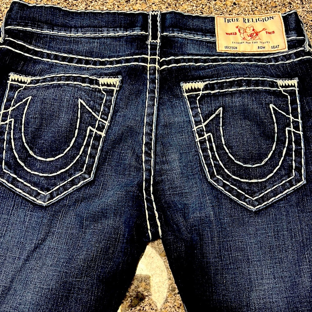 33 relaxed skinny True Religion jeans. Dark wash with light blue stitching.